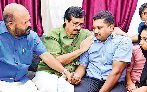 Education Minister C Raveendranath consoles Abdul Aziz, father of Shehla Sherin, at the latter’s house at Sultan Bathery on Saturday. Agriculture Minister V S Sunil Kumar looks on