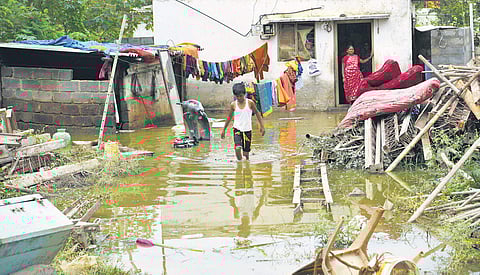 Clockwise from top: A boy wades through water just outside his house in Hulimavu on Monday
