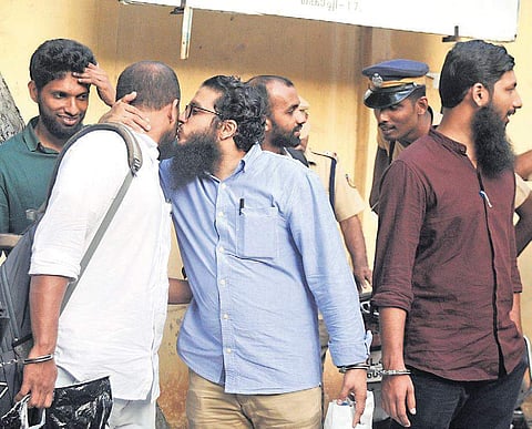 Manseed (R), the first accused in Kanakamala case, greets co-accused Moinudheen as they come out of NIA Court. Other accused Swalih and acquitted Jasim are also seen (Photo | A Sanesh, EPS)