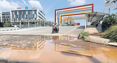 Pothole-filled roads to Infopark are creating difficulties for techies. Waterlogging in front of the Smart City entrance (Photo | Arun Angela, EPS)
