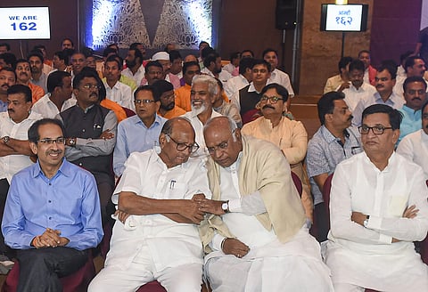 Senior Congress leader Mallikarjun Kharge NCP chief Sharad Pawar and Shiv Sena President Uddhav Thackeray Balasaheb Bhausaheb Thorat along with NCP Congress and Shiv Sena MLAs during a gathering to display their strength of 162 at Grand Hyatt Hotel in Mum