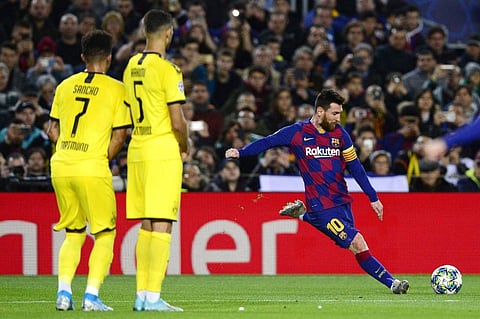 Barcelona's Argentine forward Lionel Messi shoots following a foul during the UEFA Champions League Group F football match between FC Barcelona and Borussia Dortmund at the Camp Nou stadium. (Photo | AFP)