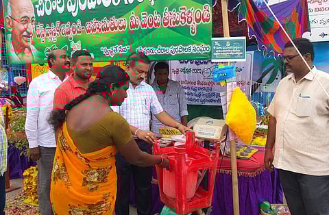 Chirala Municipal commissioner Ramachandra Reddy along with staff members inspecting the weighing of plastic waste materials at the newly established 'Waste Plastic Exchange Shop'(Photo | EPS)