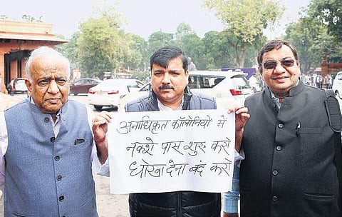 AAP MP Sanjay Singh holds a placard demanding that the Centre grants ownership to residents of unauthorised colonies in the ongoing Winter session. (Photo| Shekhar Yadav, EPS)