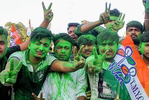 Trinamool Congress supporters celebrate after party's victory in all three assembly seats by-polls at Balurghat in South Dinajpur. (Photo | PTI)