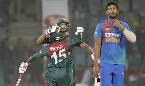 Bangladesh cricket team captain Mahmudullah, behind center, celebrates with his team member Mushfiqur Rahim after wining first T20 cricket match against India at the Arun Jaitley stadium, in New Delhi. (Photo | AP)