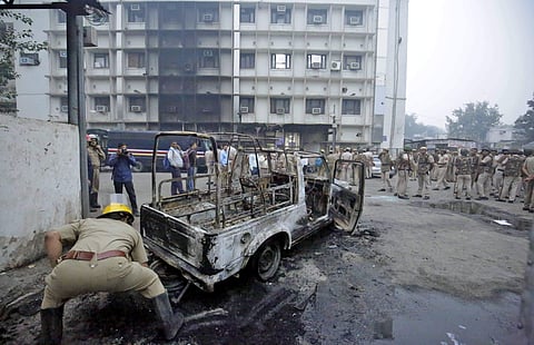 A view of a police vehicle after it was burnt down during clashes between lawyers and police personnel at Tis Hazari Court in New Delhi. (Photo | Arun kumar, EPS)