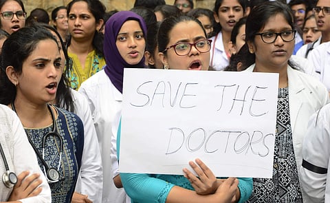 Medical students and doctors protest outside Minto Hospital on Saturday. (Photo | Shriram B N, EPS)