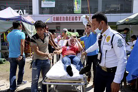 A woman is transferred to another hospital after she was injured following a quake that hit Digos, Davao del Sur, southern Philippines on Thursday Oct. 31, 2019. (Photo | AP)