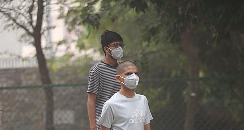 People wear masks during their morning walk in a park amid heavy smog in New Delhi. (Photo | Shekhar Yadav, EPS)