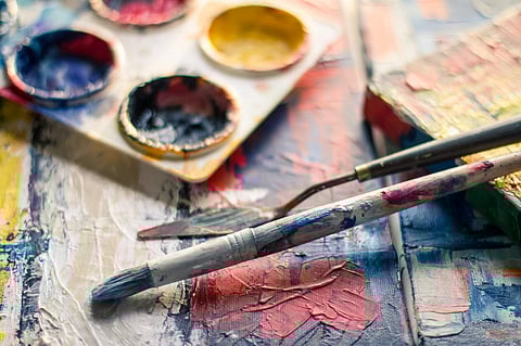 Image of paints and brushes used for representational purpose only.