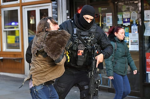 A police officer moves an uninvolved person away from a cordon after the stabbing attack incident on London Bridge in central London (Photo| AP)