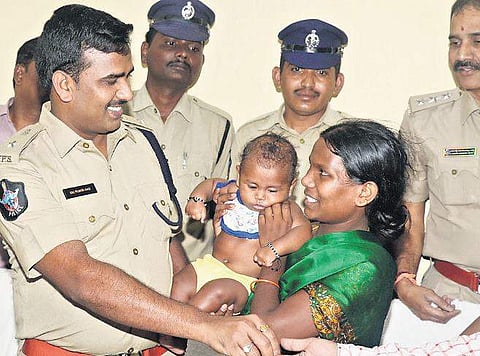SP (Rural) Ch Vijaya Rao reunites the five-month-old infant boy with his mother in Guntur on Friday | Express