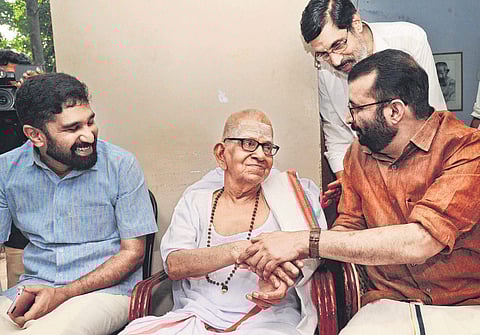 Speaker P Sreeramakrishnan and V T Balram, MLA, greeting the poet