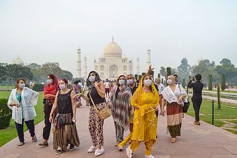 Tourists wear anti-pollution masks during their visit to Taj Mahal in Agra Monday Nov. 4 2019. | (Photo | PTI)
