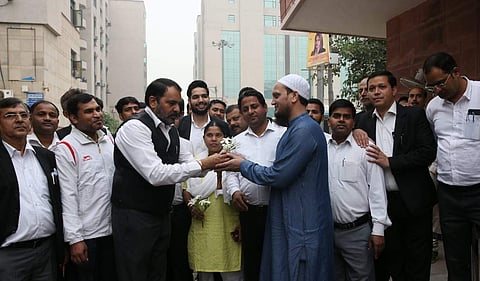Lawyers distributing flowers to the people inside the Saket court in New Delhi on Thursday. | (Photo | Shekhar Yadav/EPS)