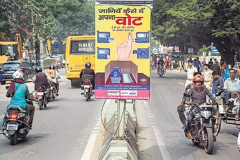 A pole banner, put up by the Election Commission, educates voters on how to vote, ahead of Jharkhand Assembly polls, in Ranchi. (Photo| PTI)