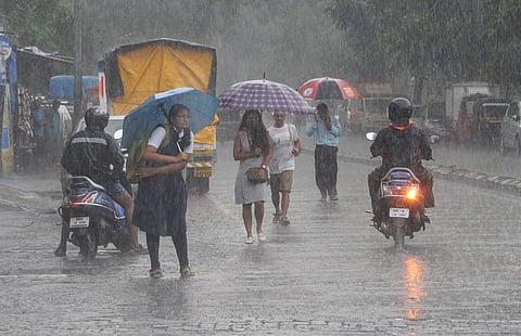 Commuters and pedestrians wade across heavy rainfall in Mumbai Friday Nov. 8 2019. | (Photo | PTI)
