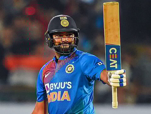 India's stand-in captain Rohit Sharma raises his bat after scoring 50 runs during the second T20 cricket match against Bangladesh at Saurashtra Cricket Association Stadium in Rajkot. (Photo | PTI)