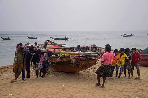 Fishermen pull their boats to away from the sea following Cyclone Bulbul warning in Puri Friday Nov. 8 2019. | (Photo | PTI)