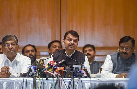 Devendra Fadnavis flanked by senior BJP leader Sudhir Mungantiwar (L) and Maharashtra BJP president Chandrakant Patil (R) interacts with media personnel after his resignation from CM post in Mumbai Friday Nov. 8 2019. | (Photo | PTI)