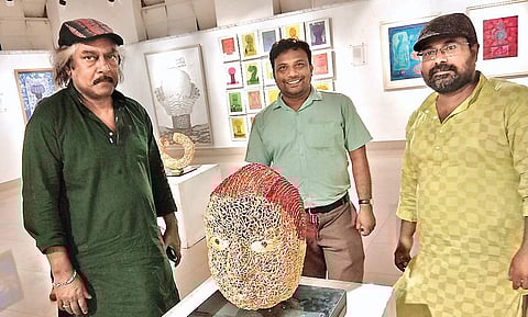 Sudipta Majumdar (centre) with his installantion and Santanu Chakraborty (right) with a visitor to the show