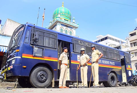 Policemen standing guard at a religious shrine at the shivajinagar in Bengaluru. (Photo | EPS)