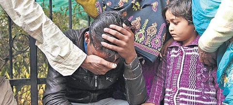 Mustkim, brother of one of the fire victims Mohammad Asaf, being consoled outside MAMC on Monday. (Photo | Arun Kumar, EPS)