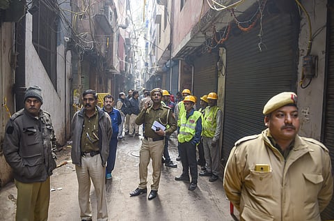 Policemen fire tenders and BSES Power members at the spot where minor fire broke out in the same factory building in Anaj Mandi where 43 workers died on Sunday in New Delhi Monday Dec. 9 2019. (Photo | PTI)