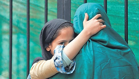 Relatives of Anaj Mandi fire victims wait outside the mortuary at Maulana Azad Medical College hospital, in New Delhi, Tuesday (Photo | Arun Kumar, EPS)