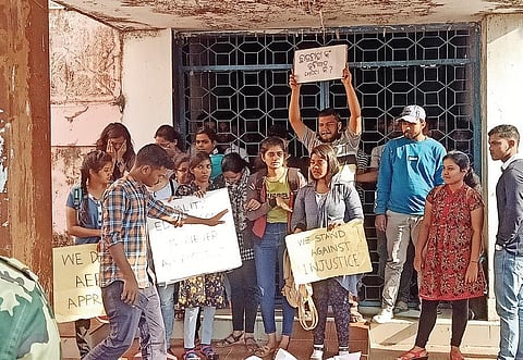Students staging demonstration in front of School of Physics in Sambalpur University. (Photo | EPS)