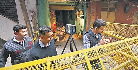 Police officers map the factory site using a 3D mapping device, in Anaj Mandi area near Filmistan, in New Delhi on Tuesday (Photo | Arun Kumar, EPS)