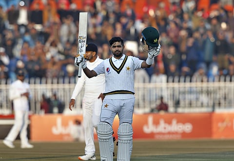 Pakistani batsman Babar Azam, left, celebrates after completing his century. (Photo | AP)