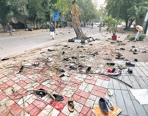 Shoes of demonstrators lie scattered along the road after the protests. (Photo | Arun Kumar)