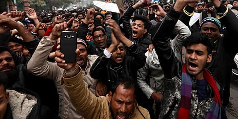 Students of the Jamia shout slogans during a protest in New Delhi. (Photo | AP)