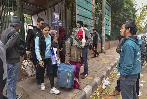 Students leave from Jamia Millia Islamia as the university is closed till Jan. 5 following the protests aginst Citizenship Amendment Act in New Delhi. (Photo | PTI)