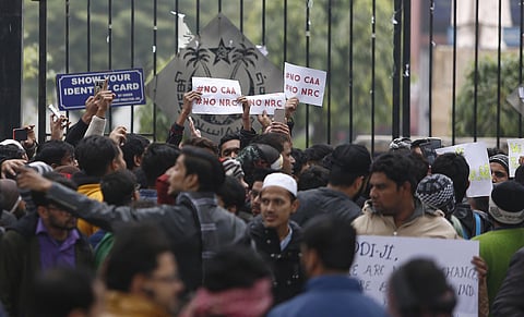 Protestors hold placards during a demonstration against the Citizenship Amendment Act outside Jamia Millia Islamia University in New Delhi| Arun Kumar