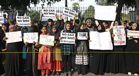 Protestors including students and local residents hold placards during a demonstration against the Citizenship Amendment Act outside Jamia Millia Islamia University| Arun Kumar