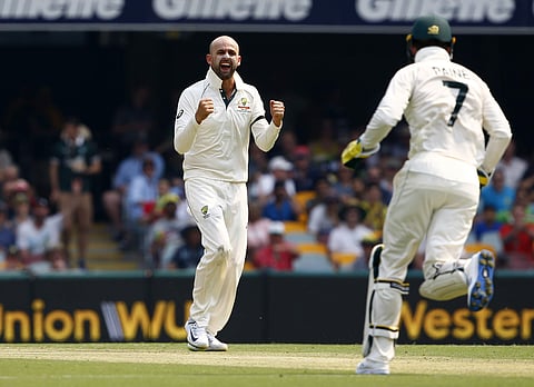 Australia's Nathan Lyon, left, reacts after getting the wicket with Australia captain Tim Paine. (Photo | AP)