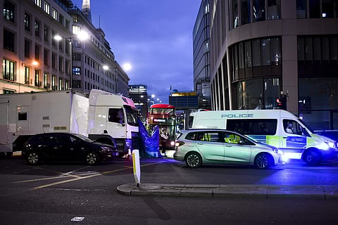 The police block is moved to allow a bus to be moved from from the scene at London Bridge in London, Sunday, Dec. 1, 2019, as police forensic work is completed following Friday's terror attack. (Photo | AP)