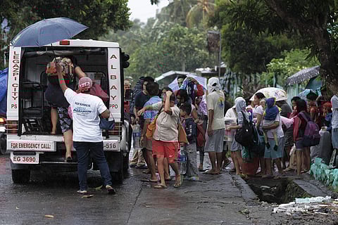 Residents evacuate their area in preparation for the coming of Typhoon Kammuri in Legazpi, Albay province, southeast of Manila, Philippines on Monday Dec. 2, 2109. (Photo | AP)