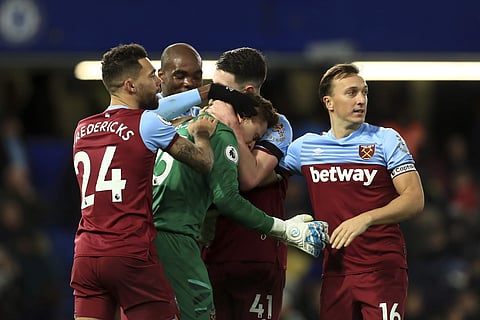 The West Ham team celebrate with West Ham goalkeeper David Martin after keeping a clean sheet during the English Premier League soccer match between Chelsea and West Ham at Stamford Bridge Stadium in London, England, in London, England, Saturday, Nov. 30,