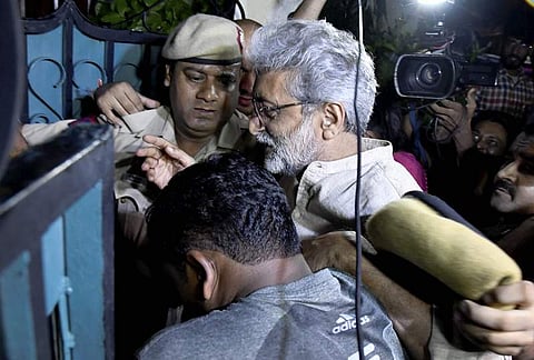 Human rights activist Gautam Navlakha being arrested by the Pune police at his residence . (File Photo | PTI)