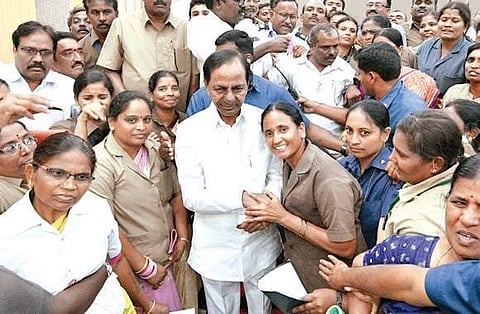 Chief Minister K Chandrasekhar Rao poses with employees of the RTC at Pragathi Bhavan in Hyderabad on Sunday.