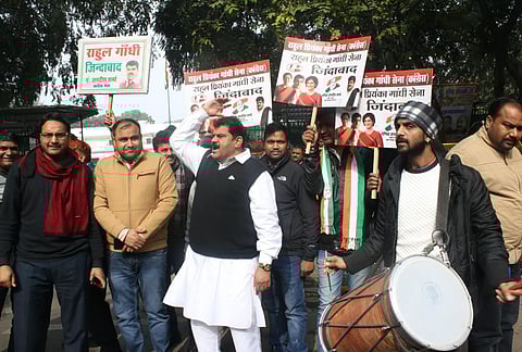 Congress workers celebrate the party's performance in Jharkhand Assembly elections as counting is underway, outside the party's headquarters in New Delhi (Photo| IANS)