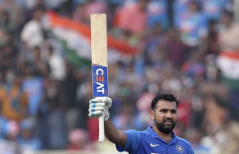 India's Rohit Sharma raises his bat to celebrate scoring a century. (Photo | AP)