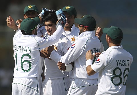 Pakistani players greet Naseem Shah after the dismissal of Sri Lankan batsman during the second Test in Karachi, Pakistan. (Photo | AP)