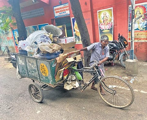 Sanitation worker pulls tri-cycle filled with garbage in Washermenpet. (PHOTO | OMJASVIN M D)