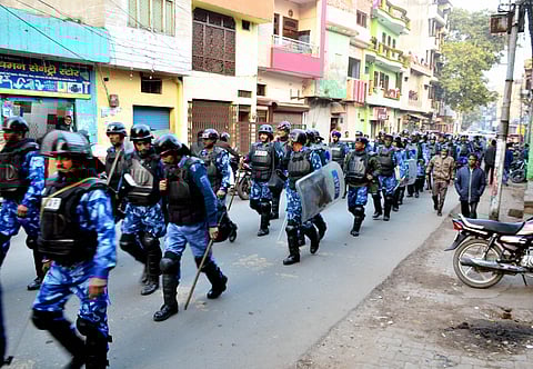 Rapid Action Force (RAF) personnel patrol a street following protests against the recently enacted Citizenship Amendment Act in several areas Moradabad Sunday Dec. 22 2019. (Photo | PTI)
