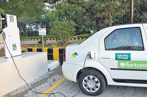 An electric vehicle replenishing charge at a charging stations